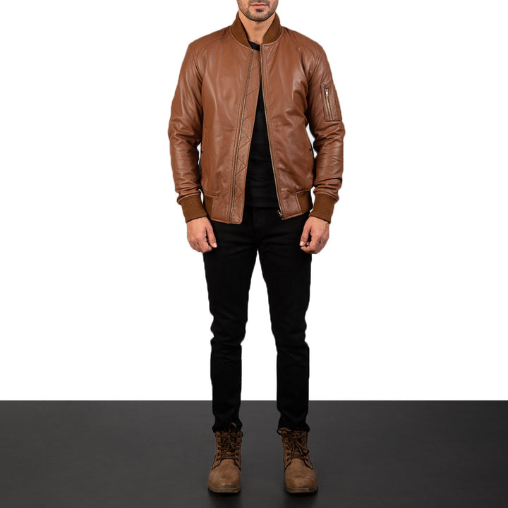 Front Side view of a male model wearing a Brown Bomia Ma-1 Leather Bomber Jacket with a standing collar, zipper closure, and rib knit cuffs, paired with a black t-shirt and black pants.