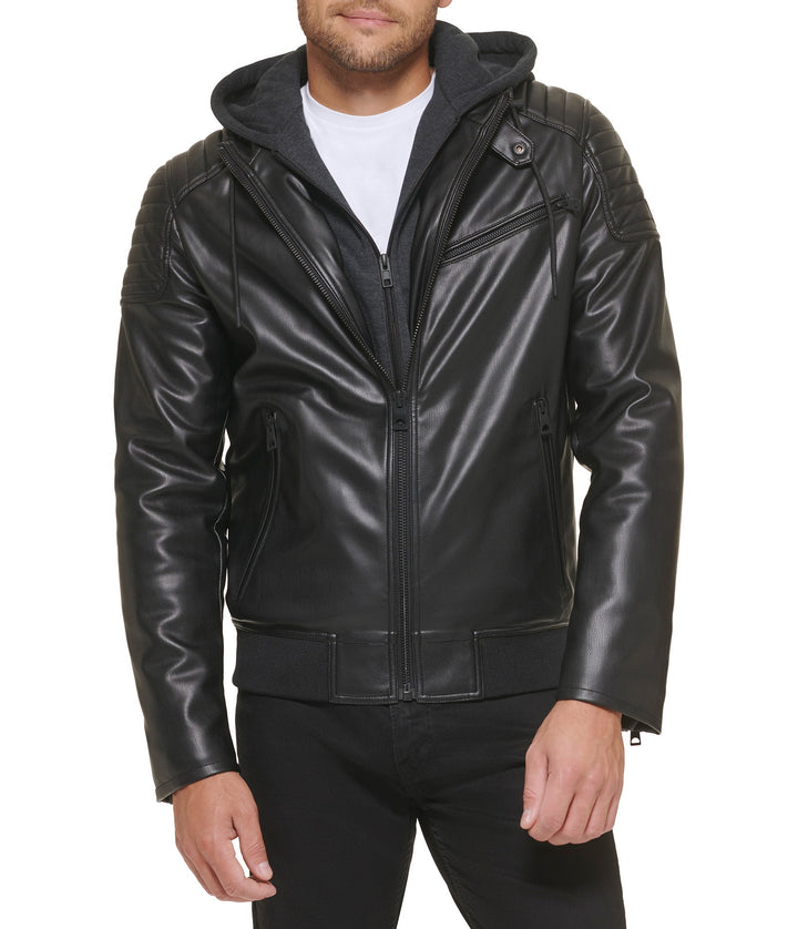 A man wearing a Faux Leather Hooded Moto Jacket with a standing collar, zippered front, and hand pockets.