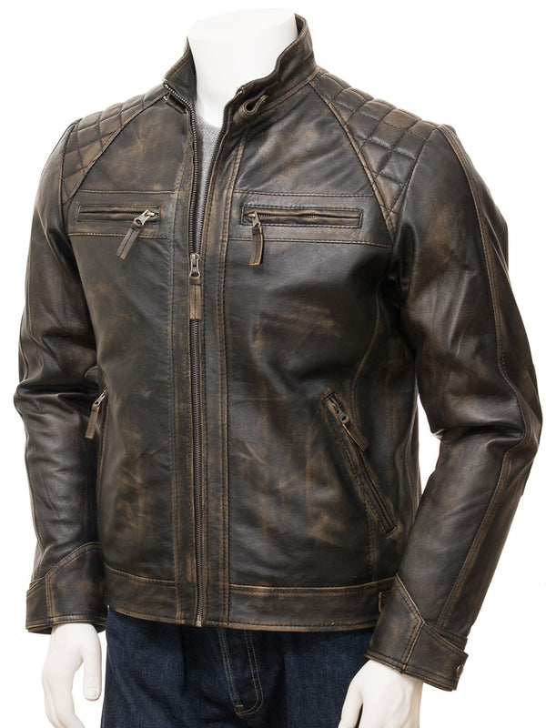 A men's black leather biker jacket with diamond topstitch detail, stand-up collar with buckle, zip pockets, and adjustable cuffs.