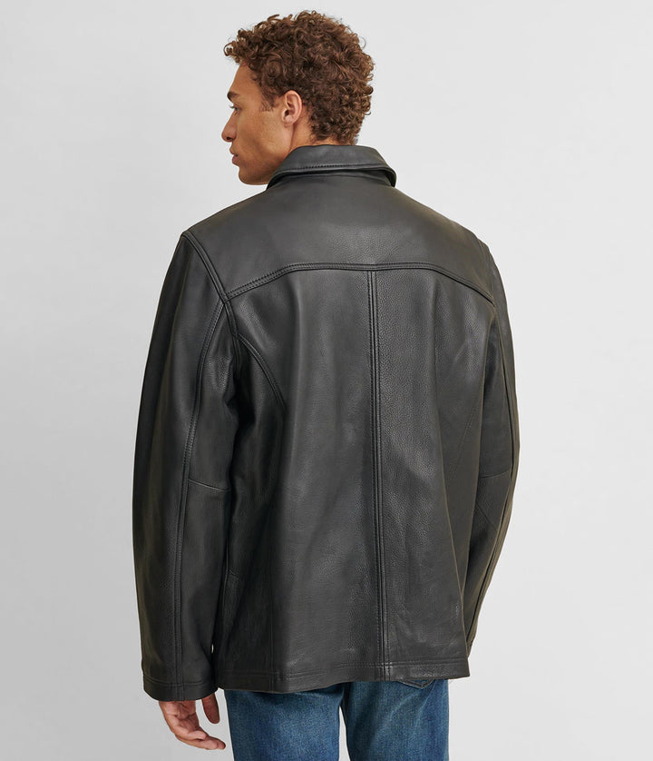 Backside view of a man wearing a Big & Tall Leather Jacket With Thinsulate Lining and two hand pockets. He also has on a maroon shirt and blue jeans.